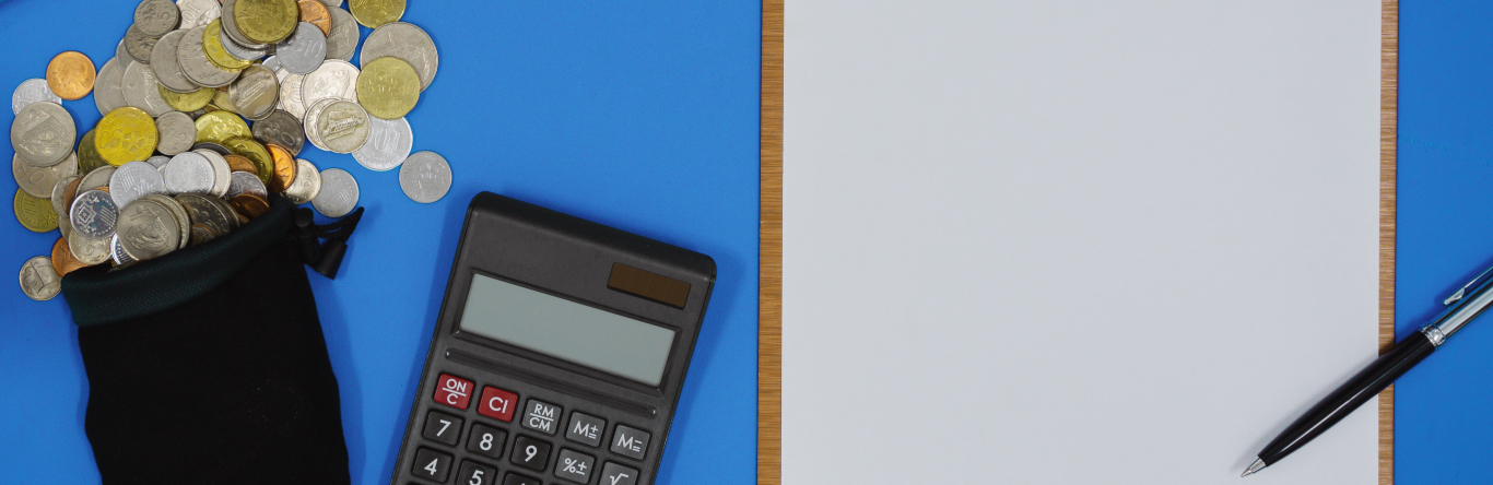 Coins Spilling From a Sack, Clipboard and Laptop on Blue Work Desk