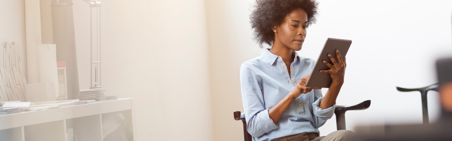 Young businesswoman using digital tablet in office