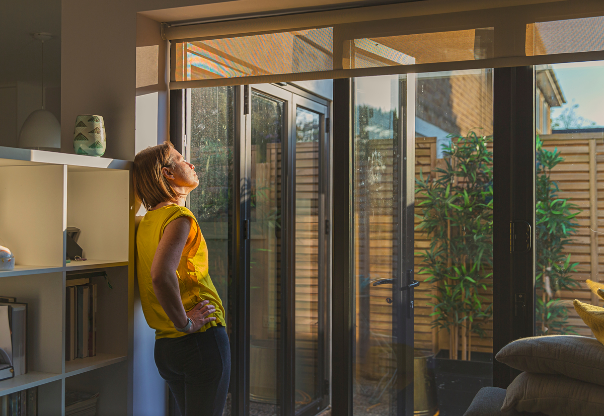 Woman standing by her back door