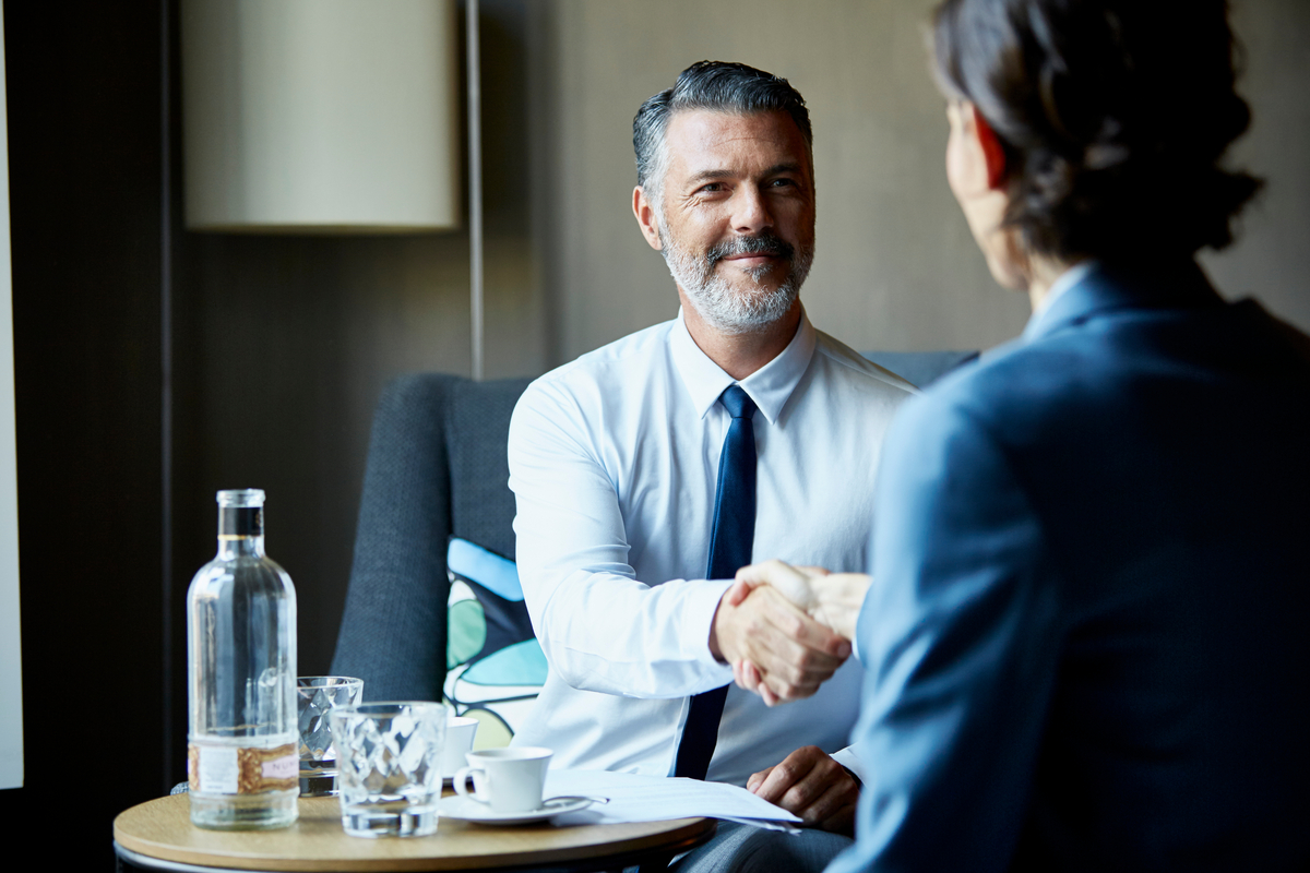 Business people shacking hands after meeting