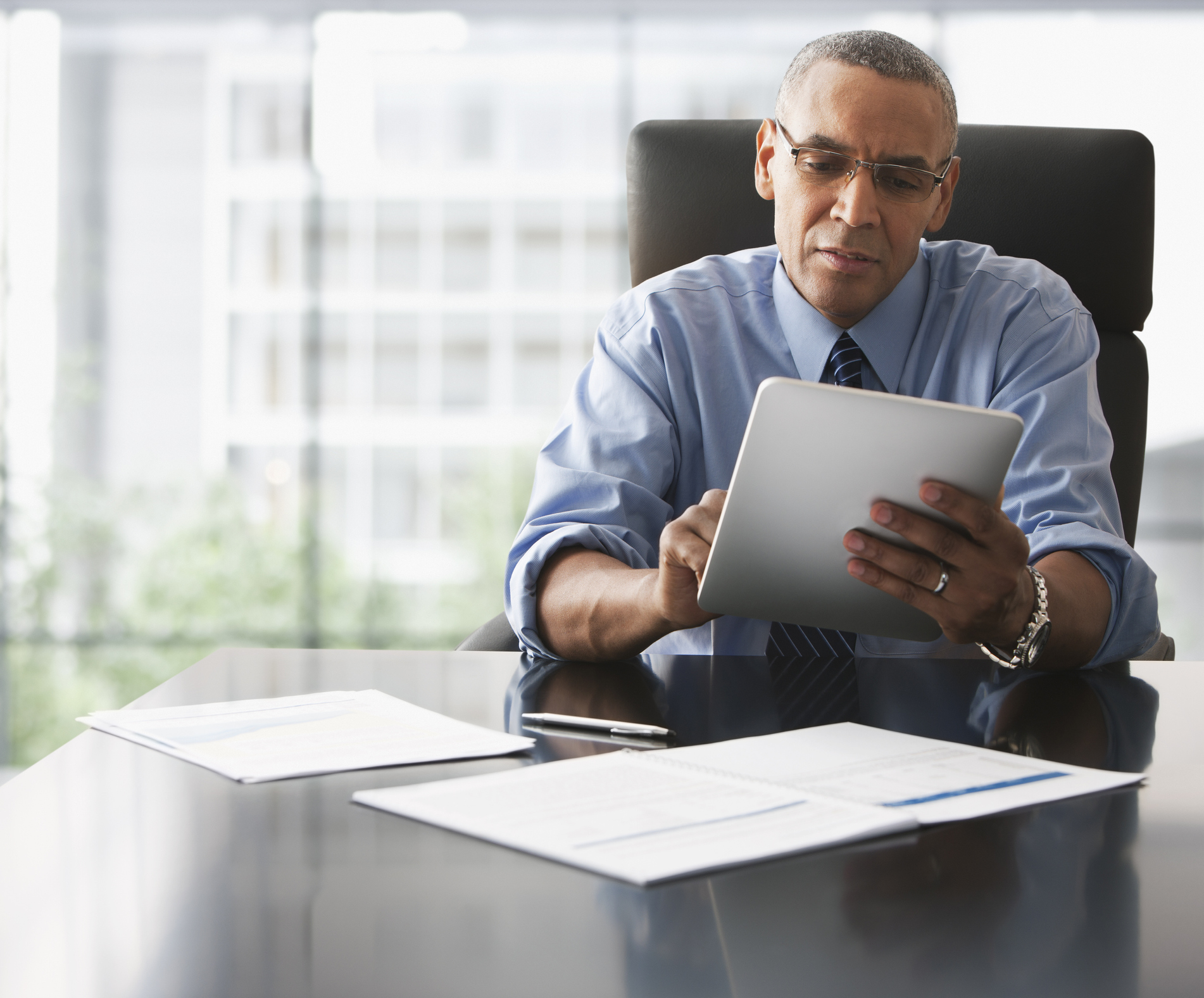 Businessman looking over electronic tablet